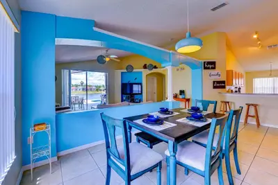 a kitchen and dining room with a table and chairs at Fascinating Lake View With Private Pool And Game-Room, Near Disney!! in Kissimmee