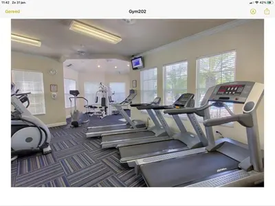 a gym with treadmills and ellipticals in a room at Mickey Holiday Home a Windsor Palms Villa in Kissimmee