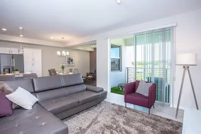 a living room with a couch and a chair at Gorgeous Two Bedroom Apto Close to Disney 306 in Kissimmee