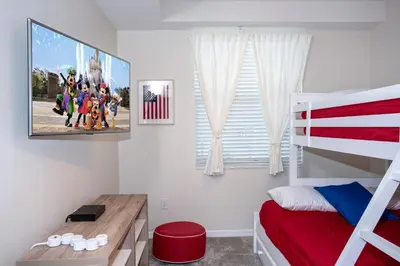 a bedroom with a tv and a bunk bed at Gorgeous Two Bedroom Apto Close to Disney 306 in Kissimmee