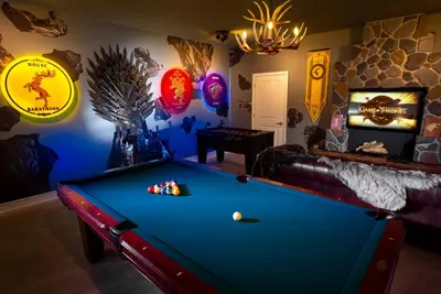 a room with a pool table and signs on the wall at B - New 4 Bedroom Home - 5 Miles to Disney - Free Water Park - Private Pool in Kissimmee
