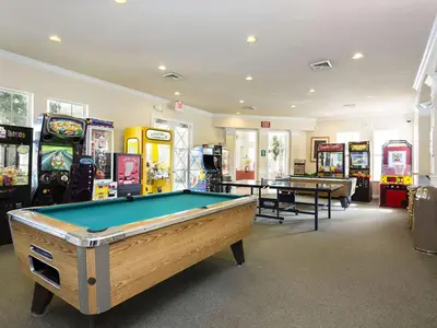 a room with a pool table and many arcade machines at Silver Palms in Kissimmee