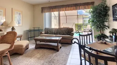 a living room with a couch and chairs and a table at Silver Palms in Kissimmee