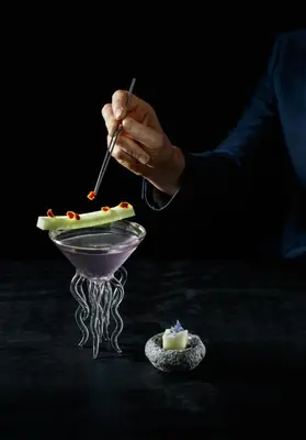 a person holding a knife and fork in a dessert at ette luxury hotel & spa - Near Disney Theme Parks in Orlando
