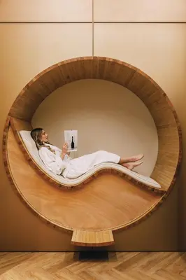 a man laying in a round bed in a room at ette luxury hotel & spa - Near Disney Theme Parks in Orlando