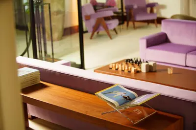 a living room with purple furniture and a table at ette luxury hotel & spa - Near Disney Theme Parks in Orlando