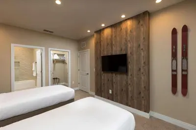 a bedroom with two beds and a wall with skis at Magic Village Views Trademark Collection by Wyndham in Orlando