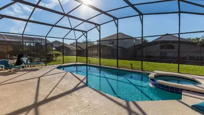 a swimming pool under a tent in a yard at Palm Key Villa 7 bed on Emerald Island Resort in Kissimmee
