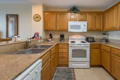 a kitchen with a sink and a stove top oven at Beautiful Apartment close to Disney, fully equipped Amazing lake views in Orlando