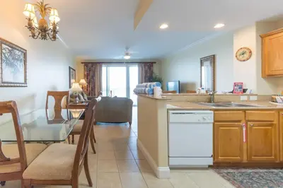a kitchen with a table and a dining room at Beautiful Apartment close to Disney, fully equipped Amazing lake views in Orlando