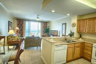 a kitchen with a sink and a living room at Beautiful Apartment close to Disney, fully equipped Amazing lake views in Orlando