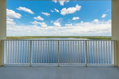 a balcony with a view of the water at Beautiful Apartment close to Disney, fully equipped Amazing lake views in Orlando