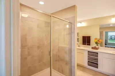 a shower with a glass door in a bathroom at H - New 2 Bedroom Condo - 5 Miles to Disney - Free Water Park in Kissimmee