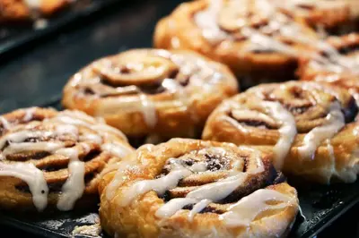 a bunch of donuts with icing on a tray at Holiday Inn Express Hotel & Suites Orlando - Apopka by IHG in Orlando