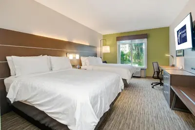 a hotel room with two beds and a television at Holiday Inn Express Hotel & Suites Orlando - Apopka by IHG in Orlando