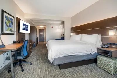 a hotel room with a bed and a desk at Holiday Inn Express Hotel & Suites Orlando - Apopka by IHG in Orlando