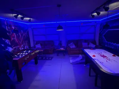 a room with two ping pong tables and purple lights at Windsor Hills Resort 5BR Villa, Amenities, Private Pool & Water Park, Near Disney, Sea World, Universal in Orlando