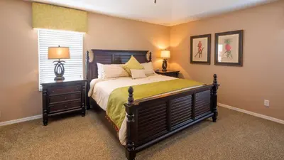 a bedroom with a large bed and a window at Minnie and Mickeys Mansion - Emerald Island in Kissimmee