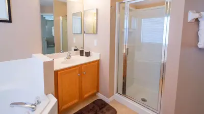 a bathroom with a shower and a sink at Minnie and Mickeys Mansion - Emerald Island in Kissimmee