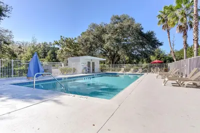 a swimming pool with chairs and a fence at Studio 6 Extended Stay - Kissimmee, FL - Orlando in Orlando
