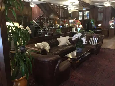 a living room with leather couches and a table at Park Plaza Hotel Orlando - Winter Park in Orlando