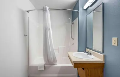 a bathroom with a shower curtain and a sink at Extended Stay America Select Suites - Orlando - Sanford - Airport in Sanford