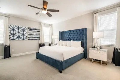 a bedroom with a blue bed and a ceiling fan at Fabulous Home With Air Hockey, Media Room And Waterpark & Resort Access Near Disney At Encore Resorts Reunion - 290Fl in Kissimmee