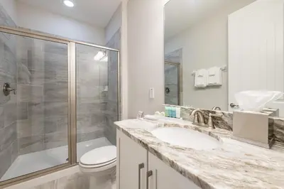 a bathroom with a toilet and a sink and a shower at Fabulous Home With Air Hockey, Media Room And Waterpark & Resort Access Near Disney At Encore Resorts Reunion - 290Fl in Kissimmee