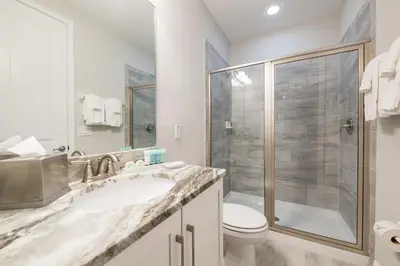 a bathroom with a shower and a sink and a toilet at Fabulous Home With Air Hockey, Media Room And Waterpark & Resort Access Near Disney At Encore Resorts Reunion - 290Fl in Kissimmee