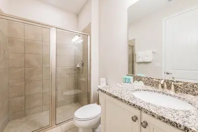 a bathroom with a shower and a toilet and a sink at Welcoming Home With Air Hockey Table And Waterpark & Resort Access Near Disney At Encore Resorts Reunion - 321Bu in Kissimmee