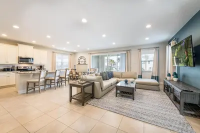 a living room with a couch and a table at Welcoming Home With Air Hockey Table And Waterpark & Resort Access Near Disney At Encore Resorts Reunion - 321Bu in Kissimmee