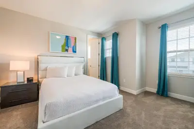 a bedroom with a white bed and blue curtains at Cozy Home With Private Pool, Air Hockey Table And Themed Room Near Disney With Waterpark & Resort Access At Encore Resort - 7458Mr in Kissimmee