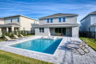 a swimming pool in the backyard of a house at Cozy Home With Private Pool, Air Hockey Table And Themed Room Near Disney With Waterpark & Resort Access At Encore Resort - 7458Mr in Kissimmee