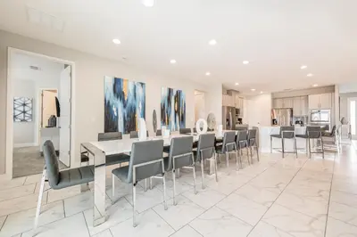 a dining room with a table and chairs at Remarkable Home Near Disney With Theater & Themed Rooms With Waterpark & Resort Access At Encore Resort - 7660Ff in Kissimmee