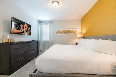 a bedroom with a large bed and a dresser at Remarkable Home Near Disney With Theater & Themed Rooms With Waterpark & Resort Access At Encore Resort - 7660Ff in Kissimmee