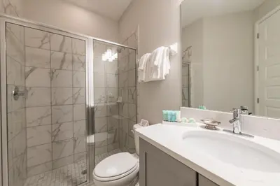 a bathroom with a shower and a toilet and a sink at Remarkable Home Near Disney With Theater & Themed Rooms With Waterpark & Resort Access At Encore Resort - 7660Ff in Kissimmee