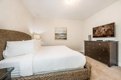a bedroom with a white bed and a dresser at Cozy Home With Private Pool, Air Hockey Table Near Disney With Waterpark & Resort Access At Encore Resort - 7702Gr in Kissimmee