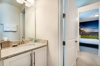 a bathroom with a sink and a mirror at Chic Home With Mini Soccer Field, Golf Near Disney With Waterpark & Resort Access At Encore Resort - 7715Ff in Kissimmee