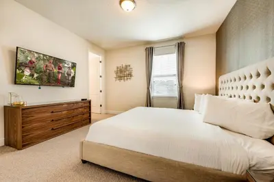 a bedroom with a large white bed and a window at Chic Home With Mini Soccer Field, Golf Near Disney With Waterpark & Resort Access At Encore Resort - 7715Ff in Kissimmee
