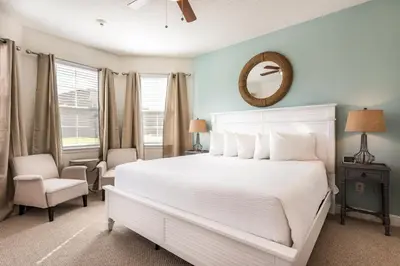 a bedroom with a white bed and a mirror at Spectacular Home With Theater, Theme Rooms Near Disney With Waterpark & Resort Access At Encore Resort - 7734Gr in Kissimmee