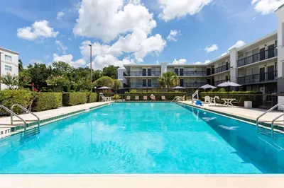 a large swimming pool in front of a building at Ramada by Wyndham Altamonte Springs Near I-4 in Orlando