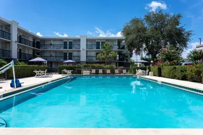 a large swimming pool in front of a building at Ramada by Wyndham Altamonte Springs Near I-4 in Orlando