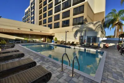 a large swimming pool in front of a building at Holiday Inn Orlando East-UCF Area by IHG in Orlando