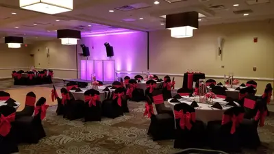a room with tables and chairs in a room with purple lighting at Holiday Inn Orlando East-UCF Area by IHG in Orlando