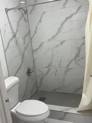 a bathroom with a toilet and a shower at Apollo Inn - Downtown in Kissimmee