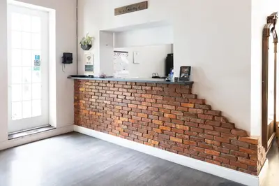a brick wall in a room with a staircase at Hunter Arms Hotel in Saint Cloud