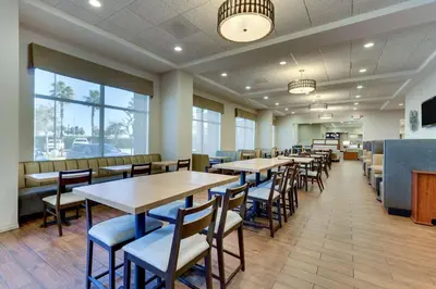 a row of tables and chairs in a restaurant at Drury Inn & Suites Orlando near Universal Orlando Resort in Orlando