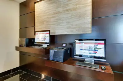 two computers sitting on a desk in a room at Drury Inn & Suites Orlando near Universal Orlando Resort in Orlando