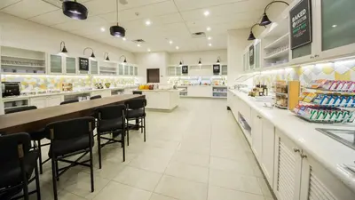 a store with a counter and chairs in a store at Hyatt Place Orlando/Lake Buena Vista in Orlando