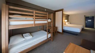 a room with two bunk beds in a hotel room at Hyatt Place Orlando/Lake Buena Vista in Orlando